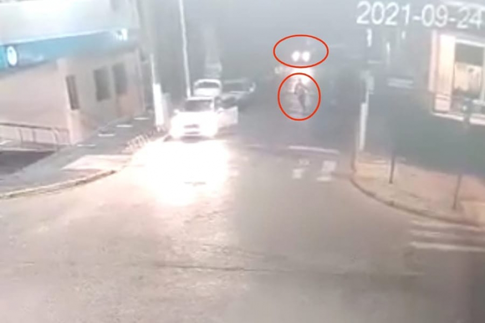 El ladrón corriendo por el medio de la calle. Detrás, la Jeep que salió en contramano.
