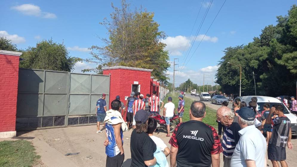 Socios e hinchas esperando por entrar mientras un grupo de la hinchada tensionaba en la ventanilla.